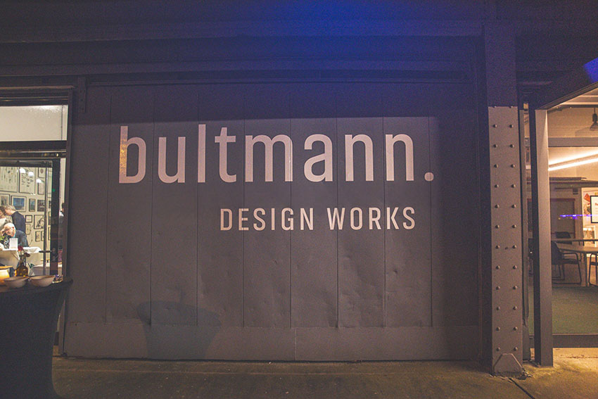 The 'Bultmann. DESIGN WORKS' logo on an industrial door at the Überseestadt location.